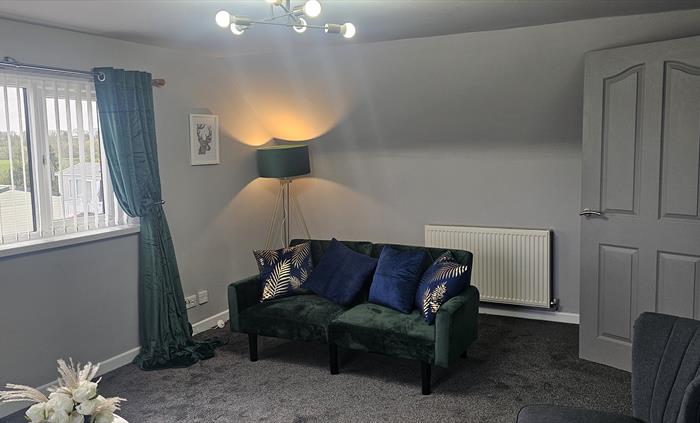 The Redford Cwtch Lounge – a cosy, welcoming space with soft seating, warm lighting, and rustic charm, perfect for relaxing with family or friends aft